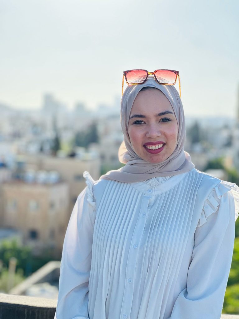 A portrait of Teacher Rania Al-Hamaida smiling, an Arabic language teacher in Amman, Jordan.