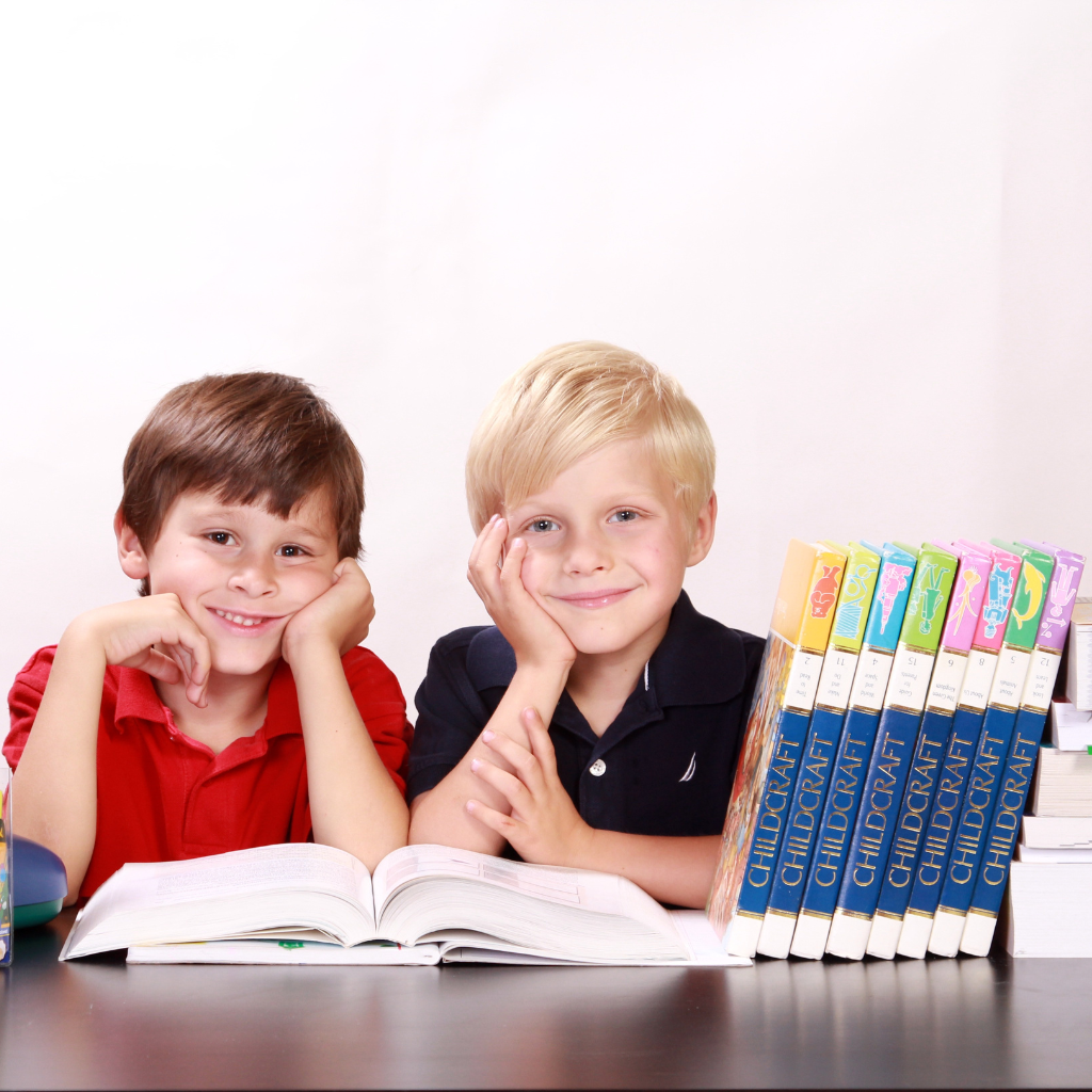Two children happily learning the Arabic language in a classroom at Misbah Center.